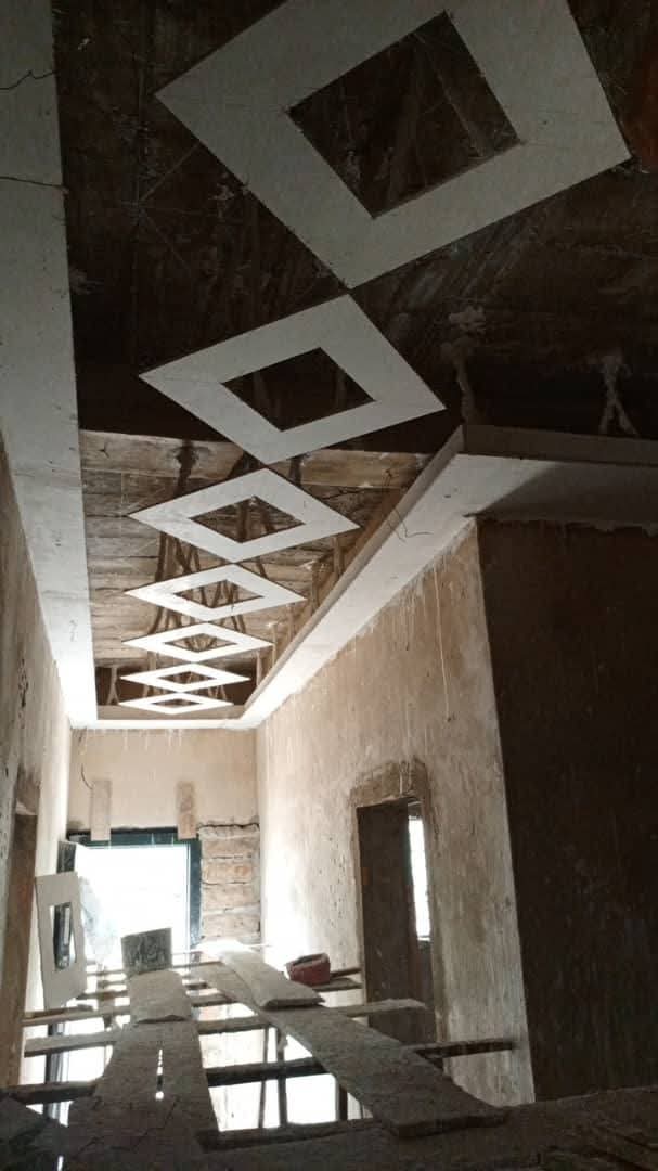 Diamond patterned POP ceiling strips installed on a corridor ceiling
