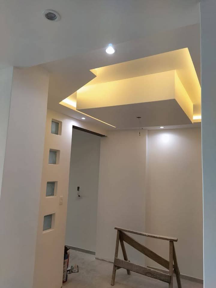 Recessed POP ceiling box with warm concealed cove lighting in a hallway